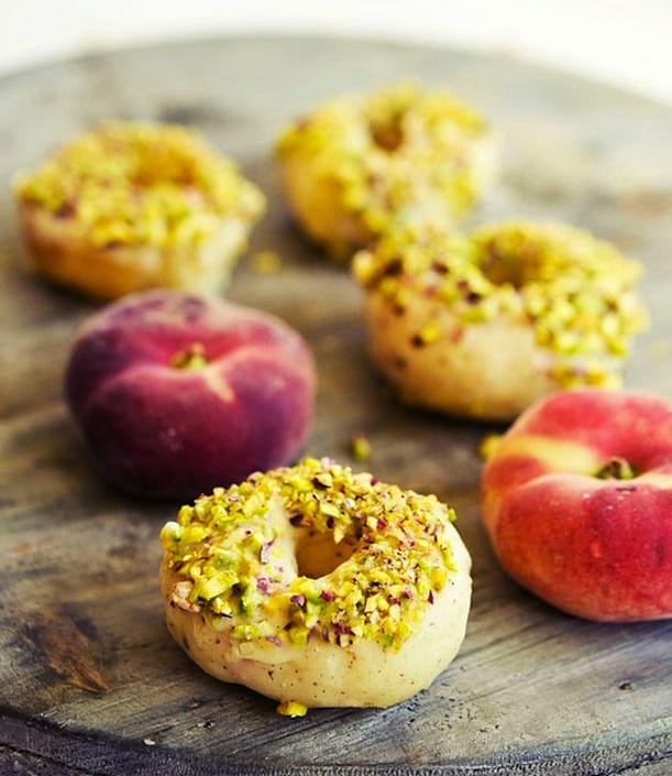 Peach glazed donuts with white chocolate and pistachios