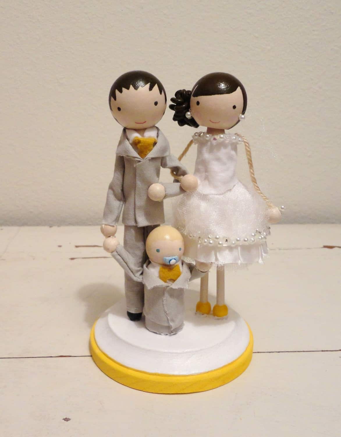 Bride, groom, and baby topper