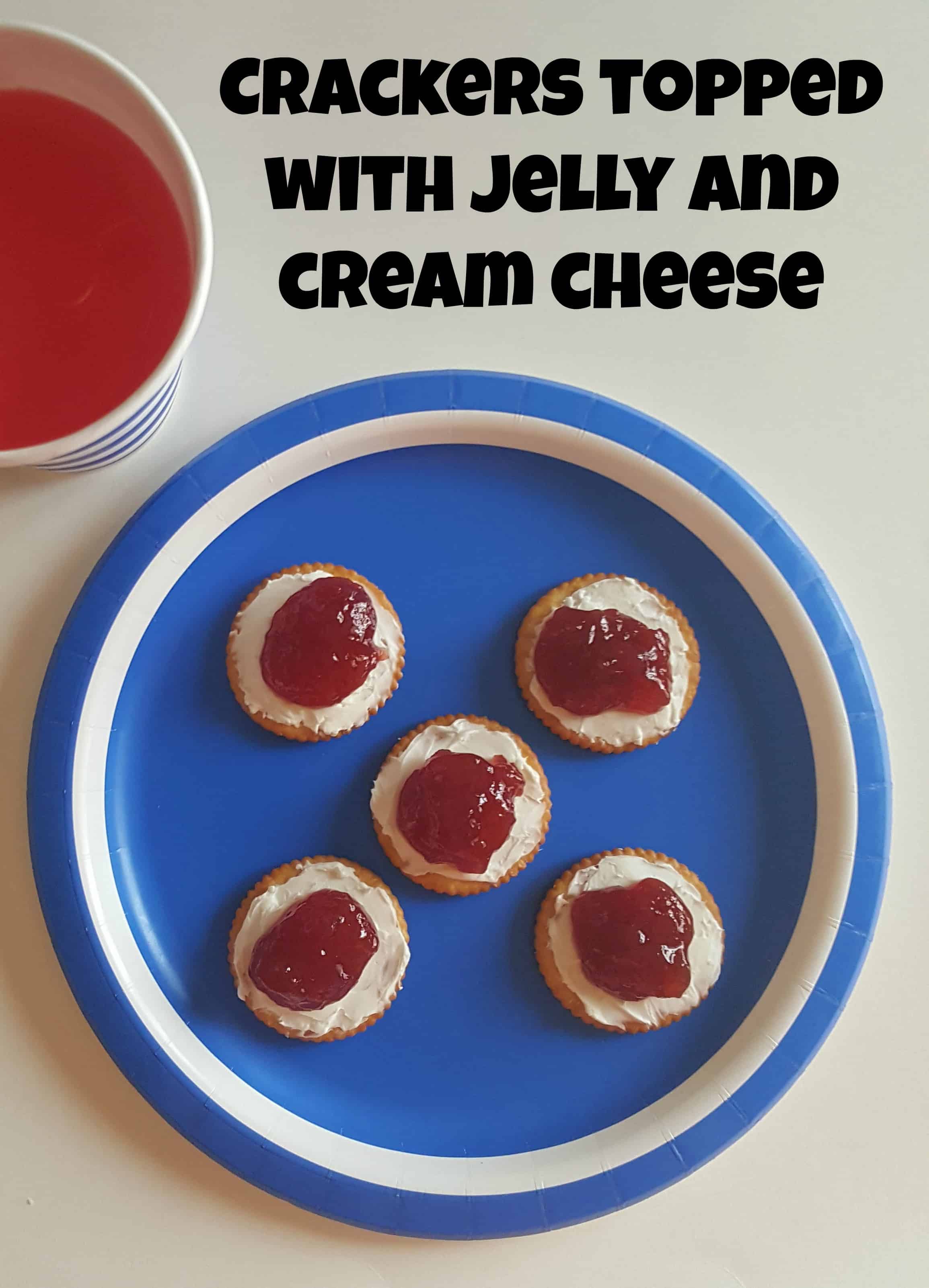 Crackers topped with grape jelly and cream cheese