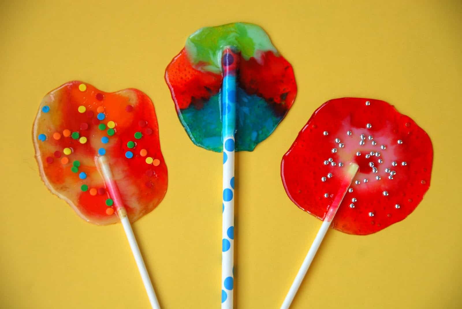 Melted candy lollipops with sprinkles
