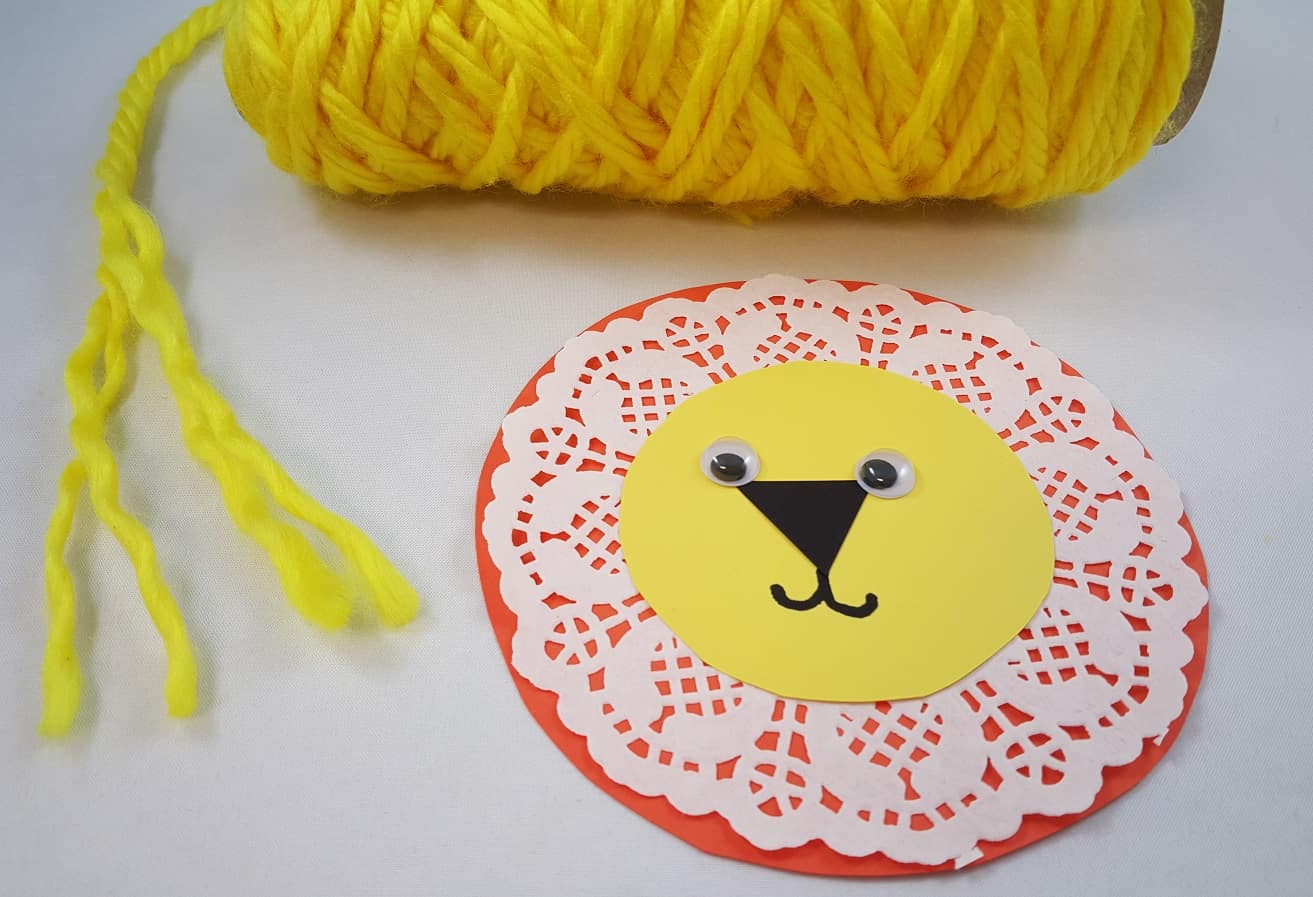 Lace paper doily and yarn lion