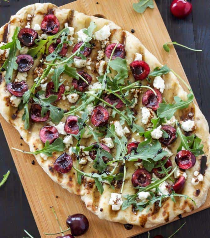 Grilled cherry, goat cheese, and arugula flatbread