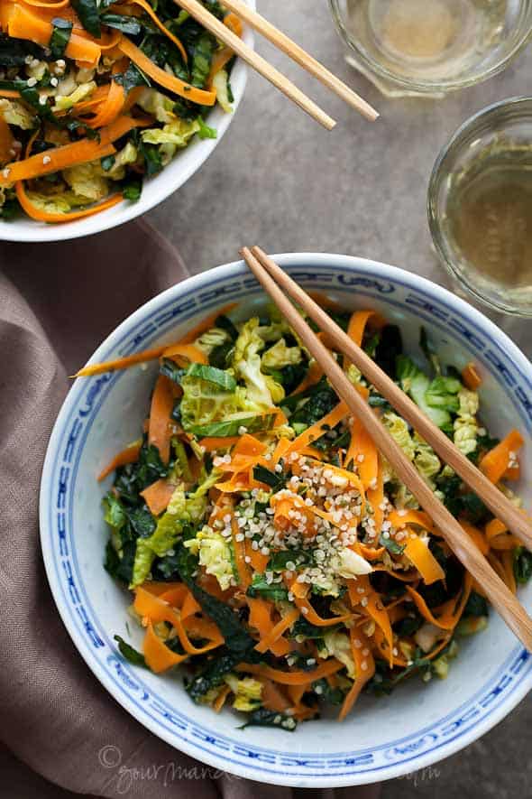 Raw kale, cabbage, and carrot chopped salad with maple sesame vinaigrette
