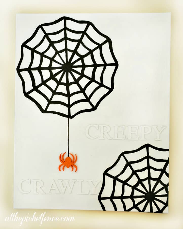 Spray pained raised letters and spider webs canvas