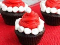 Santa hat cupcakes with marshmallows 200x150 Absolutely Awesome: 15 Holiday Themed Cupcakes to Make on The Christmas Break