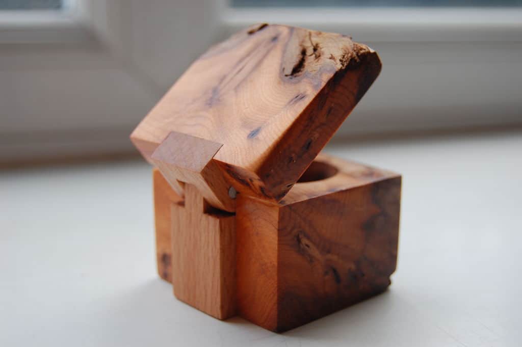 Wooden ring box with a wooden hinge
