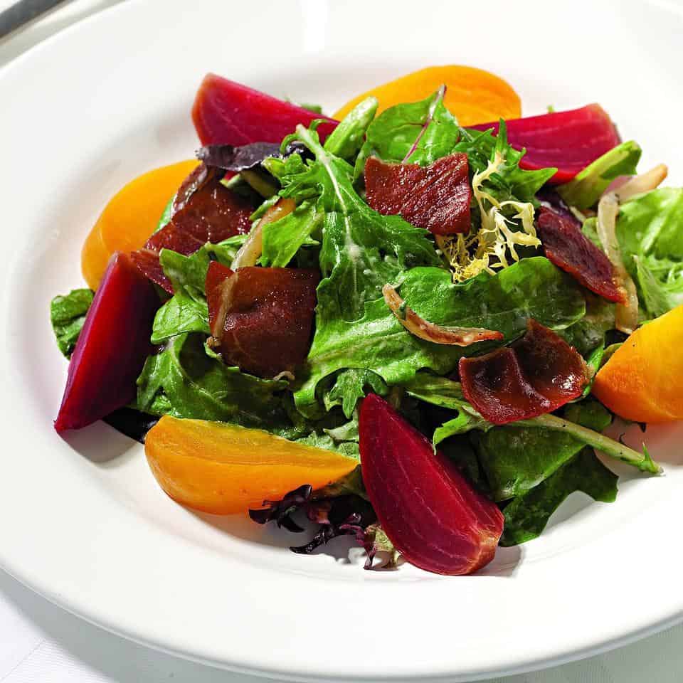 Spring salad with beets, prosciutto, and creamy onion dressing
