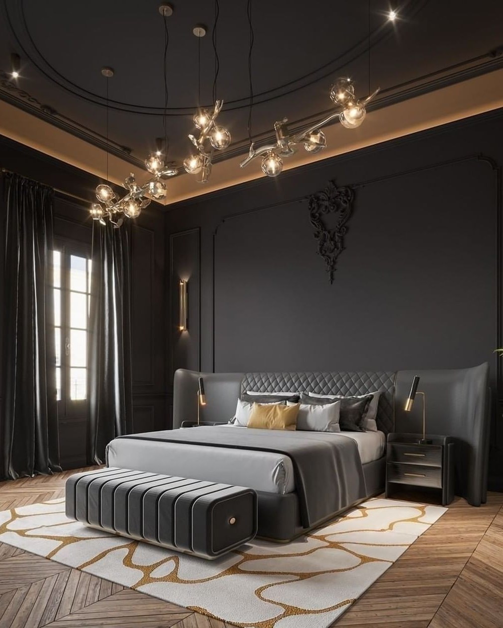 Glam master bedroom with black walls and ceiling, quilted gray leather bed, striped bench, oversized glass orb chandelier, herringbone wood floor and white rug with gold squiggle pattern