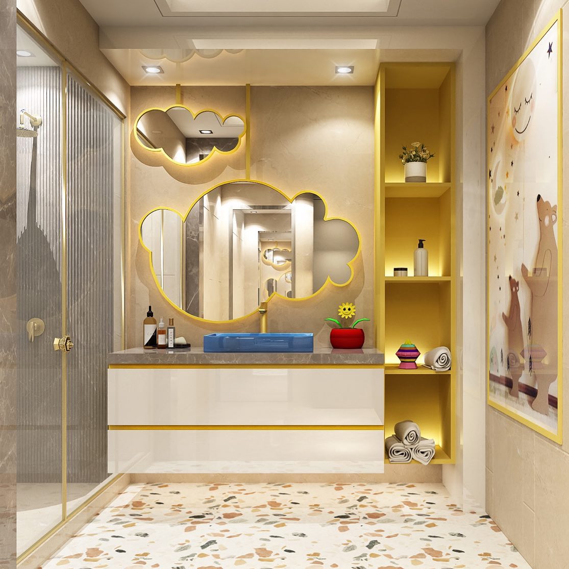 Cream and yellow kids' bathroom with cloud-shaped gold-framed mirrors, a blue trough vessel sink, confetti terrazzo floor, and a storybook bear mural panel